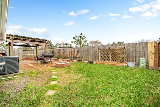 view of yard featuring an outdoor fire pit and central air condition unit