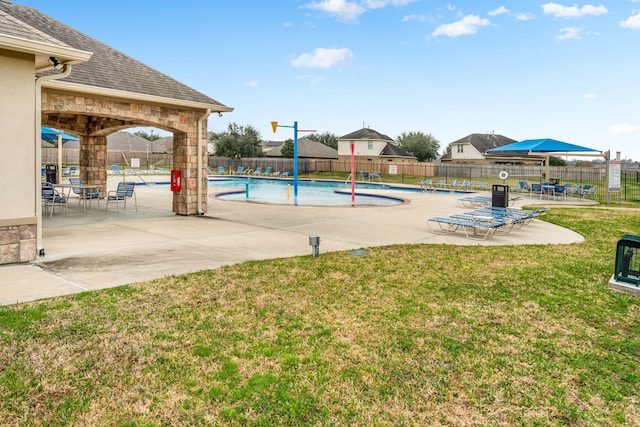 view of swimming pool with a patio and a lawn