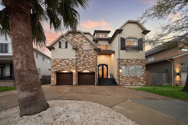 view of front of home featuring stucco siding, stone siding, a balcony, and concrete driveway