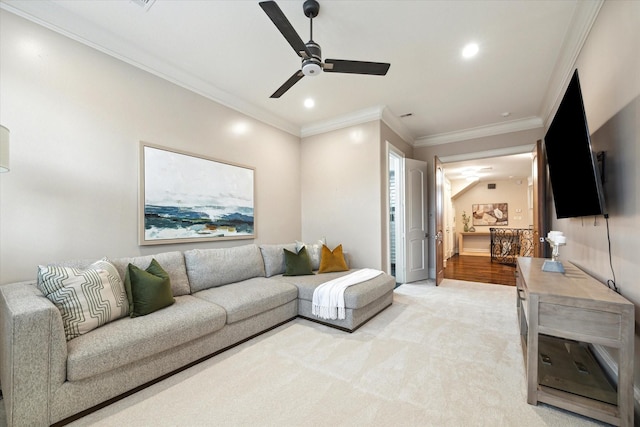 living room with ceiling fan, recessed lighting, light colored carpet, and ornamental molding