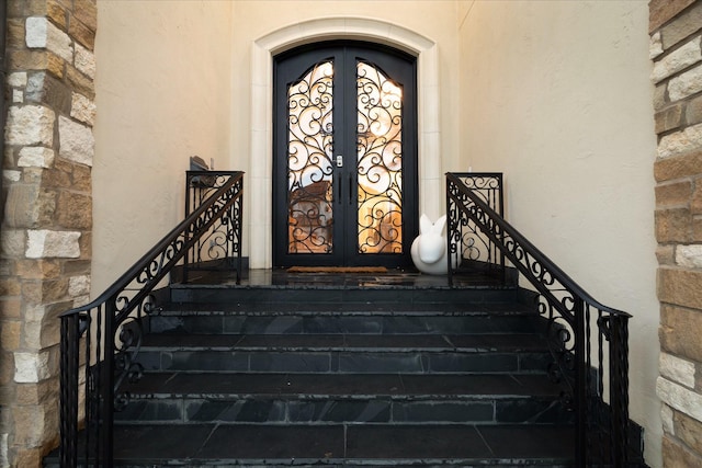 view of exterior entry featuring french doors