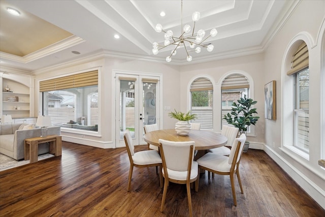 dining space featuring dark wood-style floors, plenty of natural light, french doors, and a raised ceiling