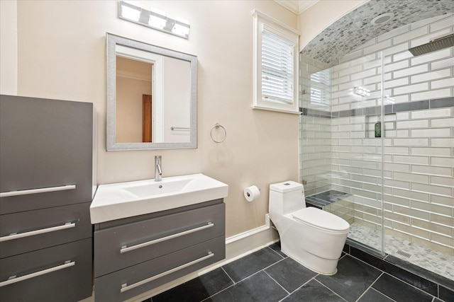 bathroom featuring tile patterned flooring, a shower stall, baseboards, toilet, and vanity