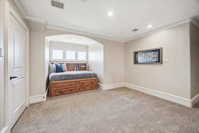 bedroom with visible vents, ornamental molding, and carpet floors