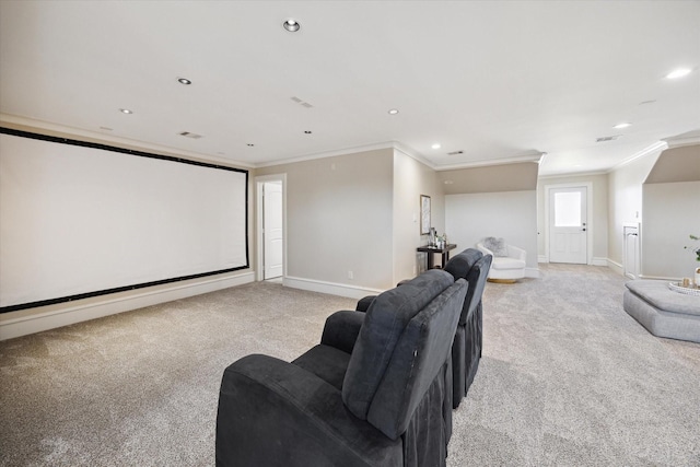 home theater with baseboards, light colored carpet, and ornamental molding