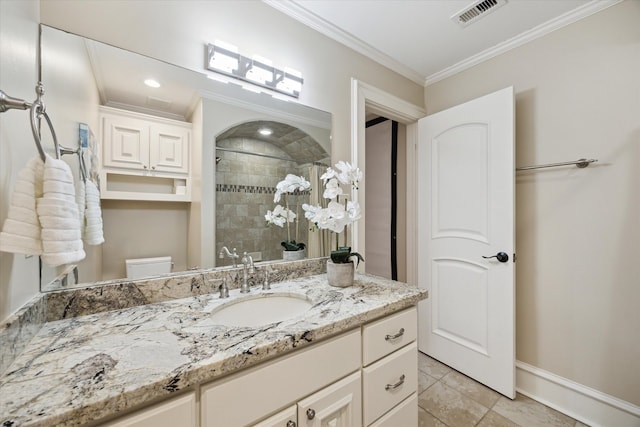 full bath with visible vents, crown molding, toilet, a tile shower, and vanity