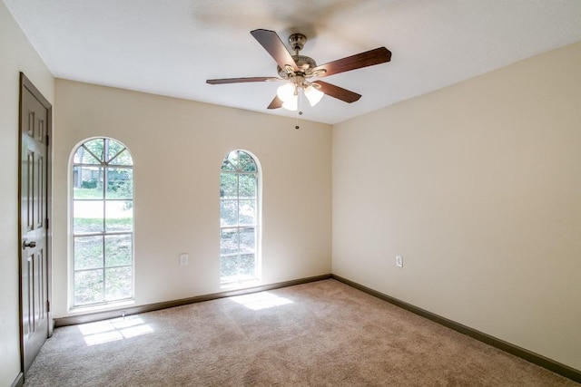 empty room with ceiling fan and light colored carpet