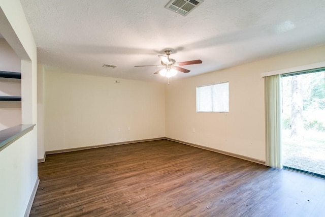 spare room featuring ceiling fan, a textured ceiling, and dark hardwood / wood-style flooring