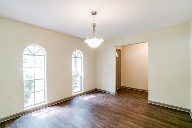 empty room with dark wood-type flooring