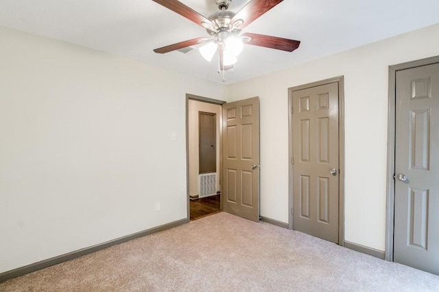 unfurnished bedroom with light carpet and ceiling fan