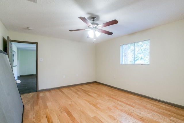 spare room with ceiling fan and light hardwood / wood-style floors