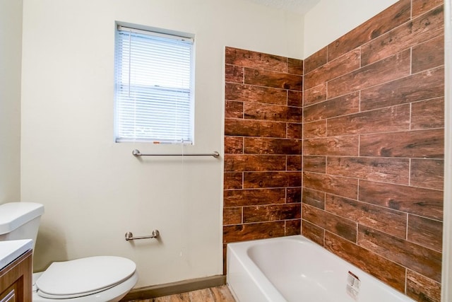 full bathroom featuring tiled shower / bath combo, vanity, hardwood / wood-style floors, and toilet