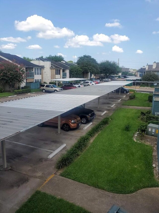 250 El Dorado Unit 296, Webster, TX 77598 - partially covered parking lot with a residential view