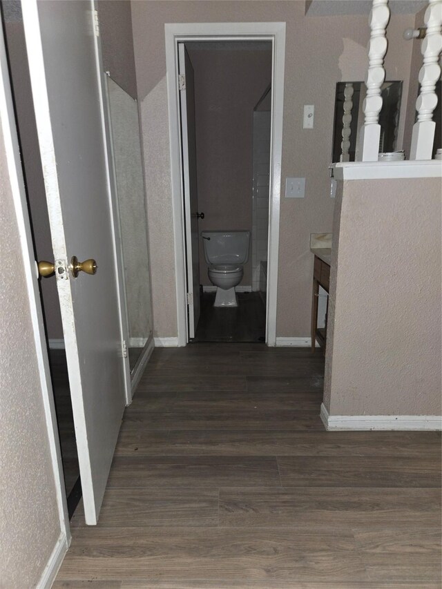 250 El Dorado Unit 296, Webster, TX 77598 - hall featuring baseboards and wood finished floors