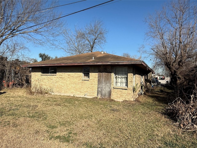 rear view of property featuring a lawn