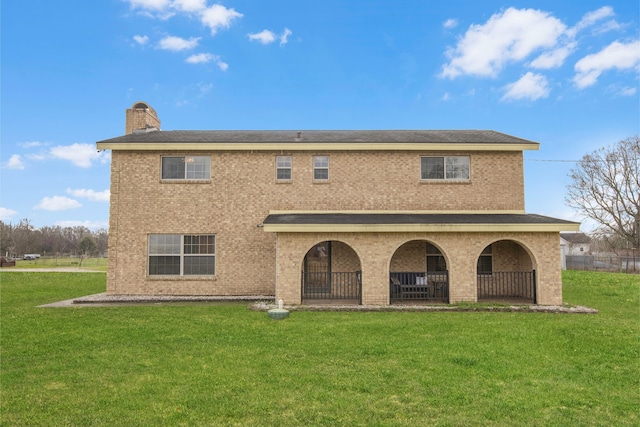 back of house with a lawn