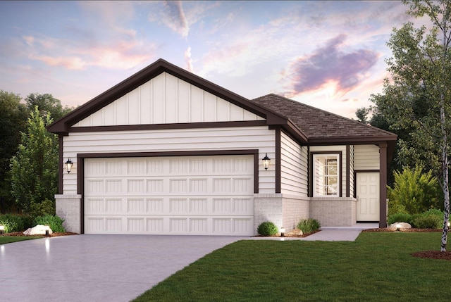 view of front of home with a garage and a yard