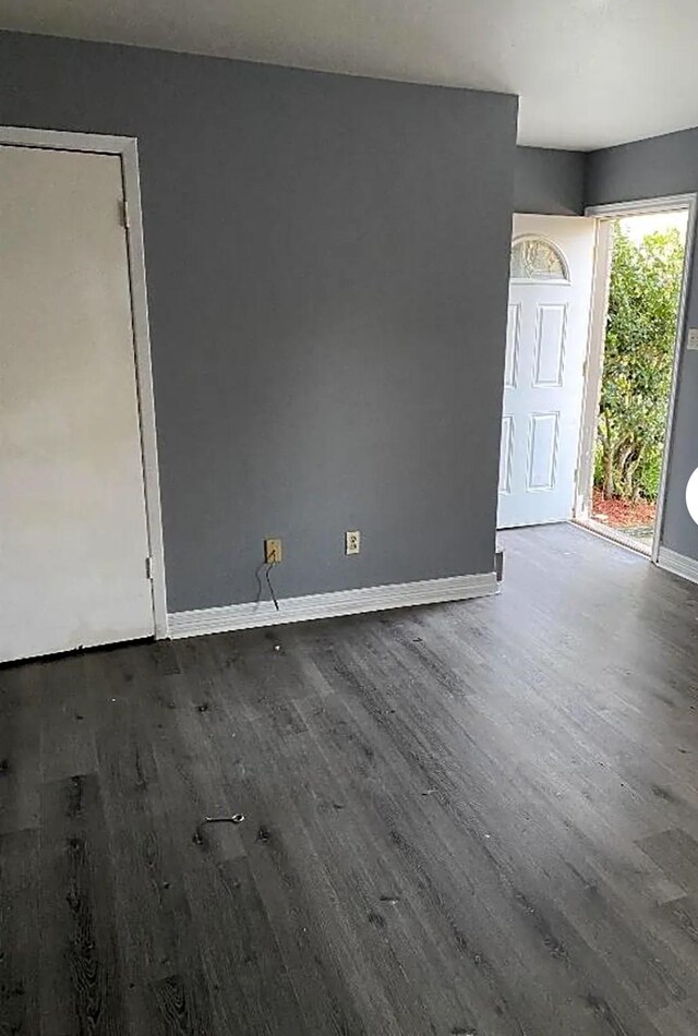 unfurnished room featuring dark hardwood / wood-style flooring