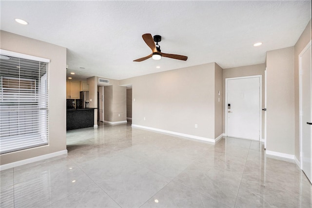 unfurnished living room featuring ceiling fan