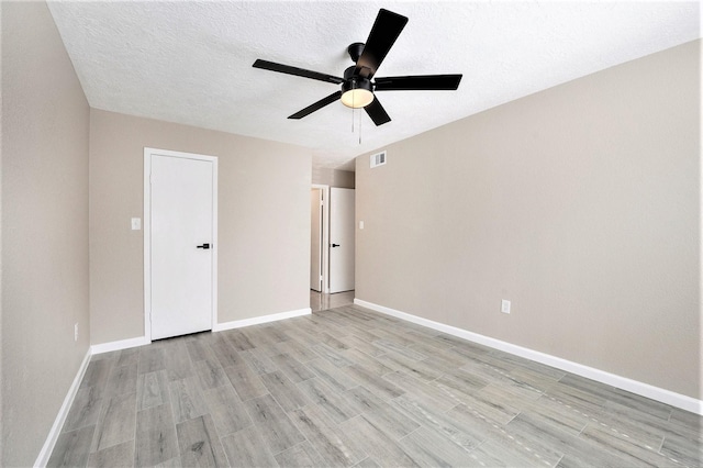 unfurnished bedroom with ceiling fan, light hardwood / wood-style floors, and a textured ceiling