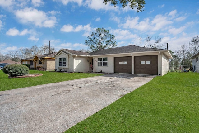 single story home featuring a garage and a front lawn