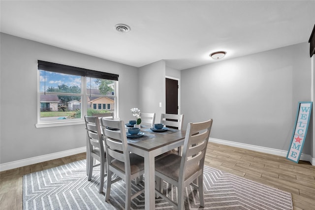 dining area featuring light wood-type flooring