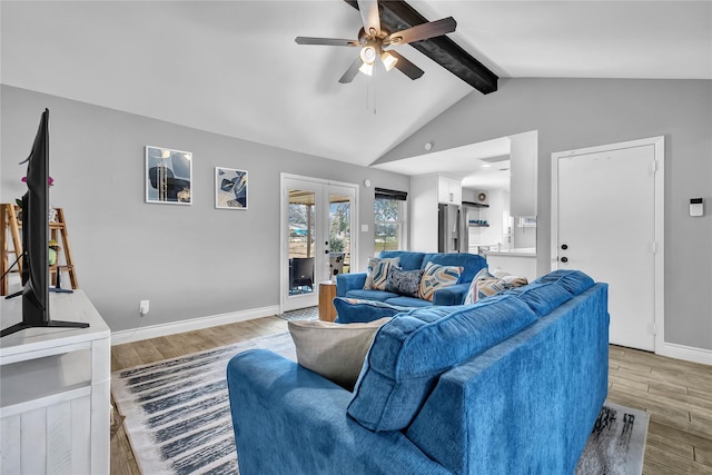 living room featuring hardwood / wood-style flooring, vaulted ceiling with beams, ceiling fan, and french doors