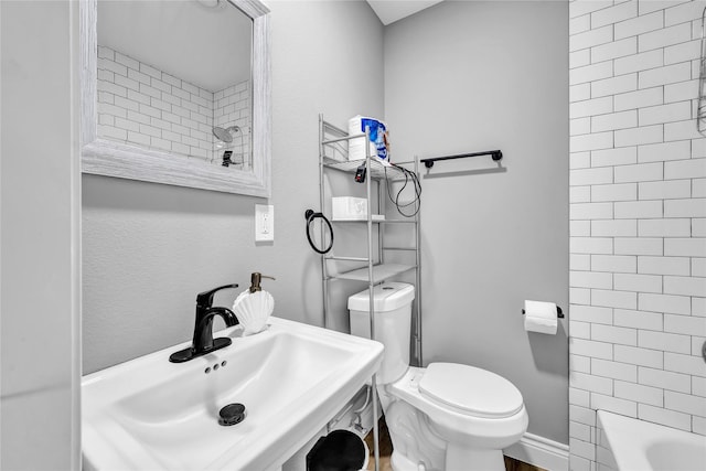 full bathroom with tiled shower / bath, sink, and toilet