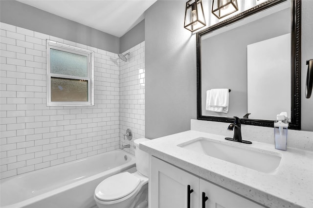 full bathroom featuring tiled shower / bath combo, vanity, and toilet