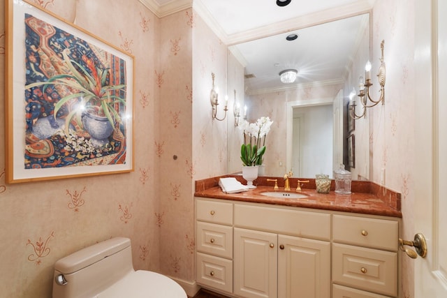 bathroom with ornamental molding, vanity, and toilet