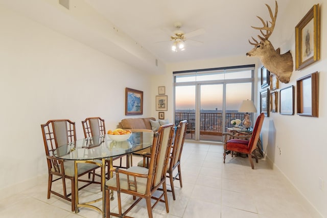 dining area with light tile patterned flooring and ceiling fan