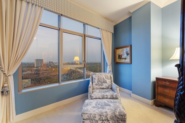 sitting room with ornamental molding and light carpet