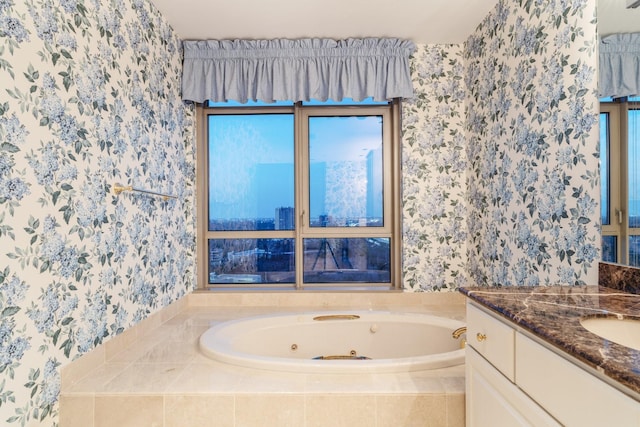 bathroom featuring vanity and tiled bath