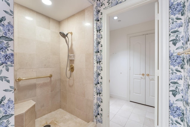 bathroom with tile patterned floors and a tile shower