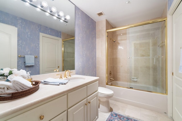 full bathroom with toilet, tile patterned floors, shower / bath combination with glass door, and vanity