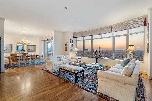 living room featuring wood-type flooring and a chandelier