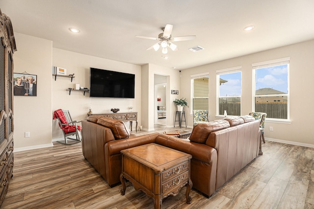 living room featuring ceiling fan and light wood-type flooring