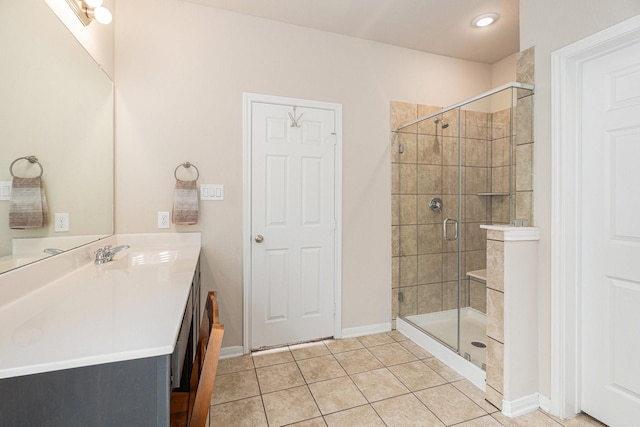 bathroom featuring vanity, tile patterned floors, and walk in shower