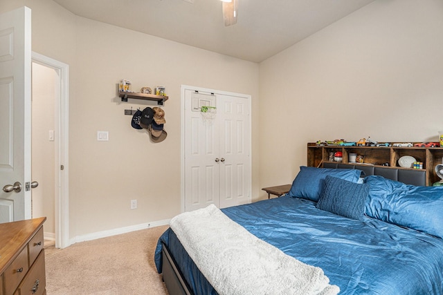 bedroom featuring light carpet, a closet, and ceiling fan