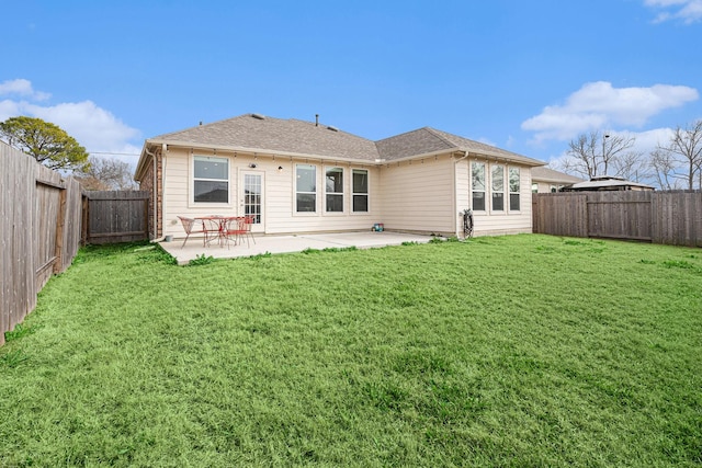 rear view of house featuring a yard and a patio area