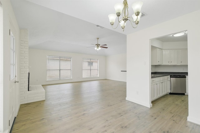 unfurnished living room featuring sink, ceiling fan with notable chandelier, and light wood-type flooring