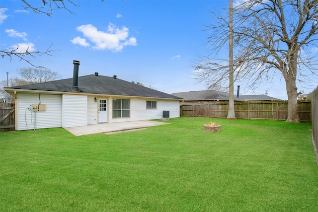 rear view of house featuring a lawn, a patio, and an outdoor fire pit