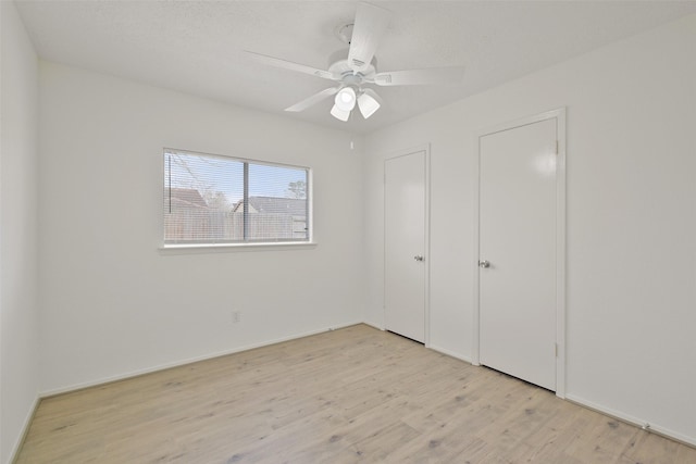 unfurnished bedroom with light hardwood / wood-style flooring and ceiling fan