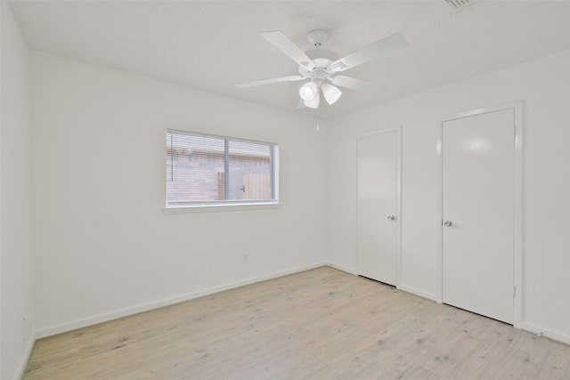 unfurnished bedroom with ceiling fan and light wood-type flooring