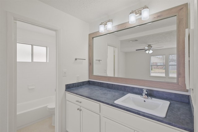 full bathroom with toilet, a textured ceiling, vanity, shower / washtub combination, and ceiling fan