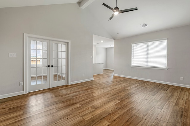 unfurnished living room with high vaulted ceiling, ceiling fan, light hardwood / wood-style floors, beam ceiling, and french doors