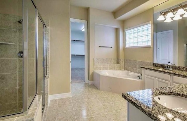 bathroom featuring vanity, tile patterned flooring, and plus walk in shower