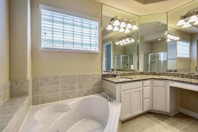 bathroom featuring tile patterned flooring, vanity, shower with separate bathtub, and a healthy amount of sunlight