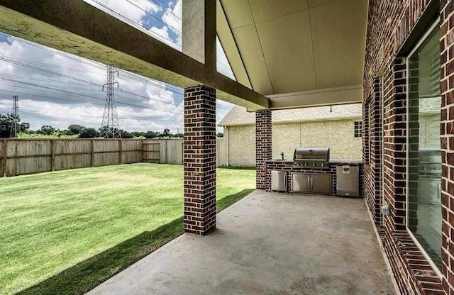 view of patio / terrace featuring an outdoor kitchen and a grill