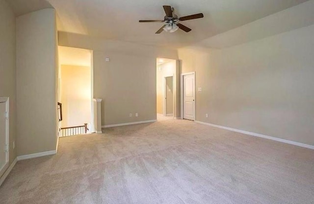 carpeted spare room with ceiling fan